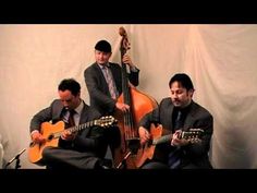 three men in suits and ties are playing guitars