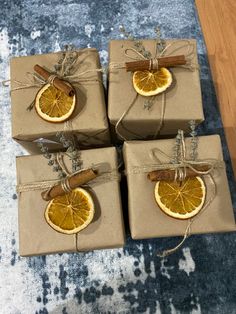 four wrapped presents with cinnamon and orange slices