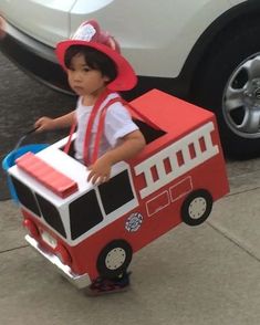 a little boy in a fire truck costume