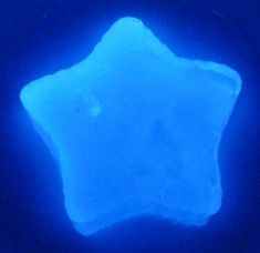 a blue star shaped object in the dark