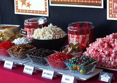 a table topped with lots of candy and popcorn