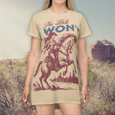 🐎You tell 'em cowgirl! This T-shirt Dress features a large-format, distressed western graphic that says: "The Hell I Won't". You will be totally rockin' your next rodeo, country concert, or county fair in true wild west style! Ideal for lots of occasions and can be worn as a dress or tunic top so you can saddle-up with your own unique look! 📦 Ships FREE in the USA! 👁️ Due to the many variations in monitors and browsers, colors may appear different on different devices. We do our best to repre Western T Shirt Dress, Fitted Graphic Print T-shirt For Western-themed Events, Fitted Western Style T-shirt For Summer, Oversized Tshirt Dress Weetern, Fitted Graphic Print T-shirt For Ranch, Western Style Relaxed Fit T-shirt With Graphic Print, Dress Western, Horse Graphic Tee, Far West