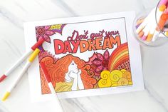 a card with the words don't put your daydream on it next to crayons and markers