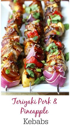 several skewers filled with meat and veggies on top of a white plate