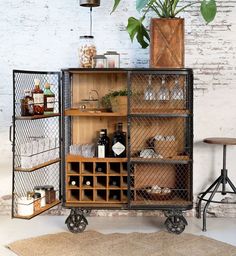 an industrial style bar cart with wine bottles on wheels