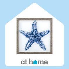 a blue and white starfish in a frame with the words at home above it