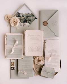 the wedding stationery is laid out on top of each other