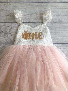 "♥ Product Information 100% Cotton in bodice and lining 100 % polyester tulle skirt Do not bleach Color is an Off White for the top and light pink for the tutu. Pumpkin age one is a gold color on the dress. Toddler tutu dress 's elastic back has a small loop to tie the strap crossover, adjust the length accordingly for a comfortable fit Beautiful baby dress has 4 layers exquisite fine tulle on the skirt with cotton lining to protect toddler girls gentle skin; Double layer front bodice with sweat Cute White Tulle Skirt Dress, Cream Princess Dress For Birthday, Cream Birthday Dress For Spring, Cream Spring Birthday Dress, Summer Princess Dress With Lace Bodice, Pink Princess Dress With Lace Bodice And Tulle, Cream Dress For Spring Birthday, Pink Tulle Princess Dress With Lace Bodice, Pink Princess Tutu Dress With Lace Bodice