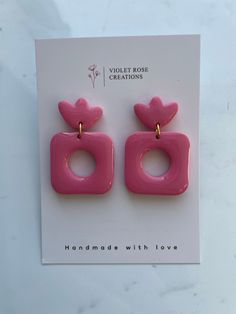 the pink earrings are shaped like hearts