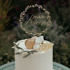 a wedding cake with lemons and greenery on top