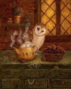 an owl sitting on top of a table next to a tea pot and some pine cones