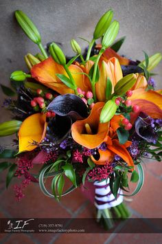 a bridal bouquet with orange and purple flowers