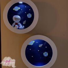 there are two round windows with space images on them