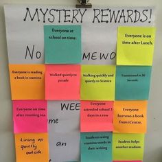 a bulletin board with sticky notes attached to it that read, mystery rewards everyone at school on time