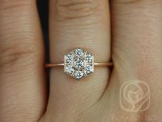 a woman's hand with a diamond ring on top of her finger and an engagement band