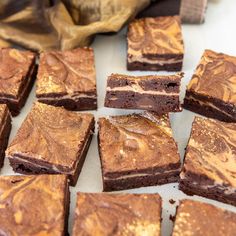 brownies with chocolate frosting sitting on a table