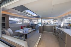 the inside of a boat with lots of counter space and seating on both sides of it