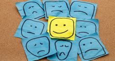 blue napkins with yellow smiley faces on them are arranged in the shape of squares