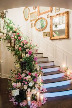 a staircase decorated with flowers and candles