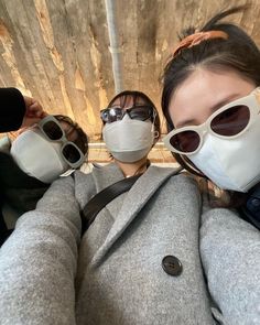 three people wearing masks and sunglasses taking a selfie