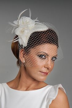 a woman wearing a veil with flowers on it