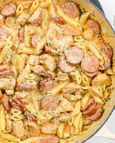 a skillet filled with pasta and sausage