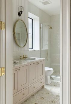 a bathroom with white and gold fixtures in it