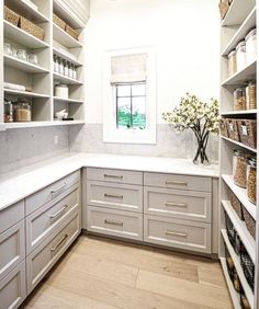 a white kitchen with lots of shelves and drawers