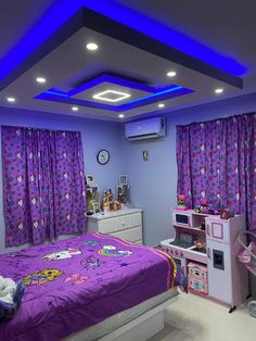 a bedroom with purple curtains and hello kitty bedspread on the bed is lit by blue lights