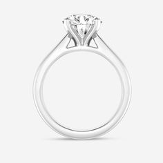 a white gold engagement ring with a round brilliant cut diamond on the center and side stones