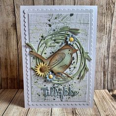 a card with a bird and flowers on it