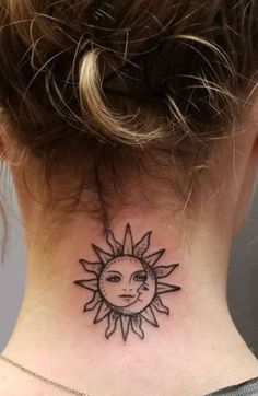 a woman's neck with a small sun tattoo on it