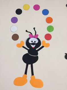 a paper cut out of a cartoon character with lots of circles on the wall behind it