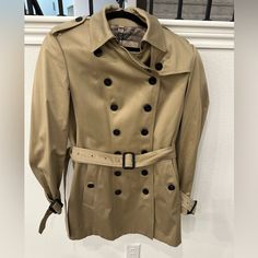 Burberry London Authentic Trench Coat Nwt. New, Tags Still Attached, Never Worn. Size Us 14. Hard To Find Size. Structured, Tailored Fit, Not Slouchy. Well Made. Free Shipping - No Additional Cost. Burberry Coat Women, Designer Gabardine Outerwear, Burberry Trench Coat Aesthetic, Burberry Long Trench Coat, Burberry Kensington Trench Coat, Classic Burberry Trench Coat, Burberry Mid Length Trench Coat, Cropped Trench Coat, Tan Coat