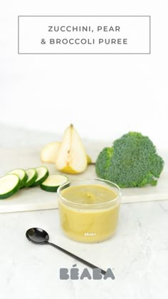 broccoli and cucumber are sitting on a cutting board with a spoon