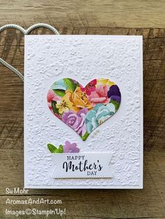 a heart shaped card with flowers on it