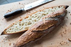 a loaf of bread sitting on top of a cutting board next to a knife