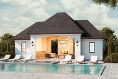 a pool house with lounge chairs next to it and a swimming pool in the foreground