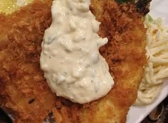 fried chicken with sauce and pasta on a white plate