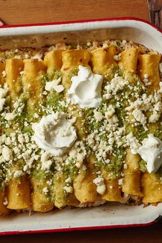 a casserole dish with broccoli, cheese and sour cream on top