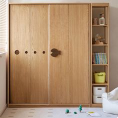 a bedroom with wooden closet doors and toys on the floor