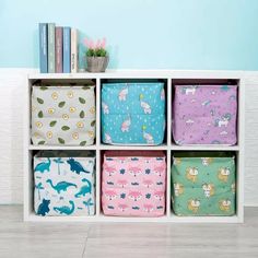 a white shelf filled with lots of colorful storage bags