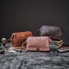 three different types of men's bags sitting on top of a table next to each other