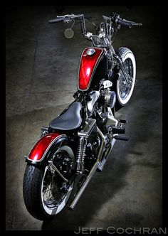 a red and black motorcycle parked in a garage