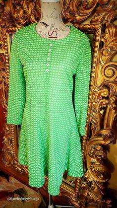 "This darling dress is from the 70's.  Made of a bright green polyester with white star pattern.  Excellent condition and quality.  Fully lined. Simple a-line silhouette with center back zipper. Decorative buttons down the front of the bodice.  Best fit would be a Medium, however, please see the measurements below for a proper fit.  All sales are final. Measurements Armpit-armpit doubled 36\" Waist 32\" Hip 48\" Length 38\"" Vintage Long Sleeve Stretch Dress, Vintage Stretch Long Sleeve Dresses, Green Fitted A-line Vintage Dress, Mod Green A-line Dress, Green Mod A-line Dress, Dress With Stars, 1970s Dresses, Darling Dress, Silk Gown