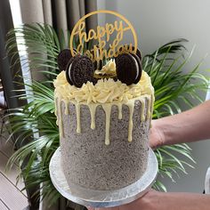 a birthday cake with oreo cookies and cream drizzled on the top