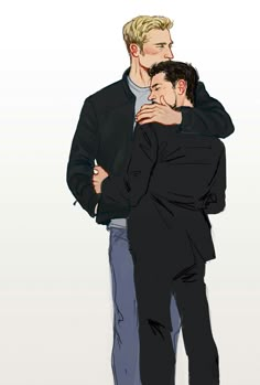 two men hugging each other while standing next to each other