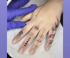 a woman's hand with tattoos on it