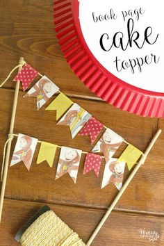 a cake topper on a wooden table with paper bunting