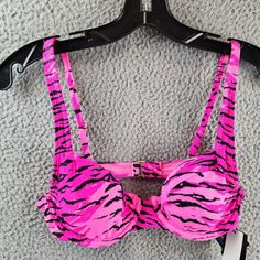 California Waves Topaz Tiger Underwire Bralette Bikini Top Juniors Small Pink California Waves Topaz Tiger Underwire Bralette Bikini Top Juniors Small Pink Elevate Your Beach Look With This California Waves Bikini Top In A Stunning Topaz Tiger Print. The Bralette Style Features Adjustable Spaghetti Straps And Underwire For Added Support. Made With A Combination Of Nylon And Spandex, This Bikini Top Is Not Only Comfortable But Also Accentuated With A Strap Detail. Hand Wash Only To Ensure A Long- Pink Swimwear With Adjustable Straps For Party, Pink Underwire Swimwear With Straps, Trendy Triangle Top Beach Bra, Strappy Beach Bra With Removable Pads, Strappy Bra For Beach, Vacation Bra With Straps, Pink Strappy Swimwear For Party, Party Swimwear With Removable Bra Pads For Beach Season, Trendy Beach Bra For Spring